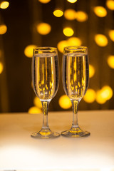 Two glasses on a background of illumination