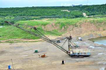 Fototapeta premium Biggest excavator dragline with a large bucket for the quarry overburden stripping. Belarus, Vitebsk, largest dolomite deposit in a open pit 