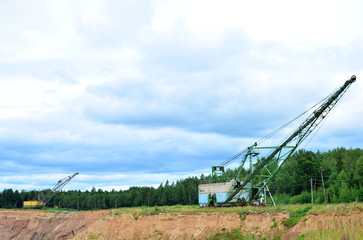 Fototapeta na wymiar Biggest excavator dragline with a large bucket for the quarry overburden stripping. Belarus, Vitebsk, largest dolomite deposit in a open pit 