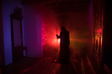Horror silhouette of ghost inside dark room with mirror Scary halloween concept Silhouette of witch inside haunted house with fog and light on background.