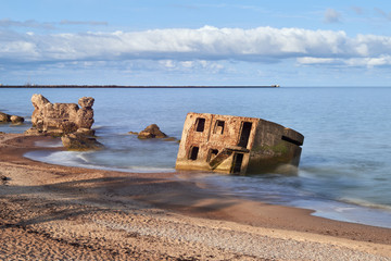 Bunker ruins near the Baltic Sea beach, part of the old fortress in the former Soviet Union base "Karosta" in Liepaja, Latvia. Photographed in summer.