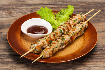 Minced pork skewer kebab with sauce