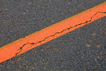 Fototapeta premium Yellow lines and crack in asphalt roads