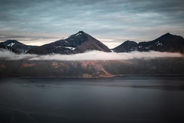 Fototapeta premium Fjord landscape in Norway with mountains and sea in the golden hour