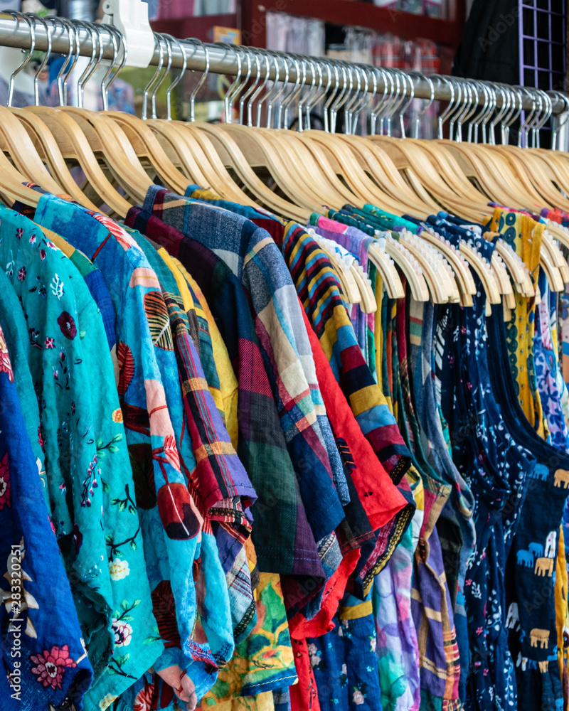 Wall mural colorful row of clothes on hangers