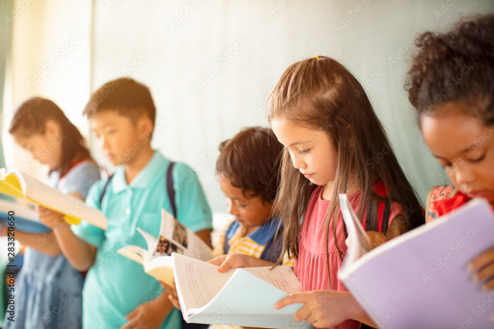 Wall mural Group of diverse young students studying in  classroom