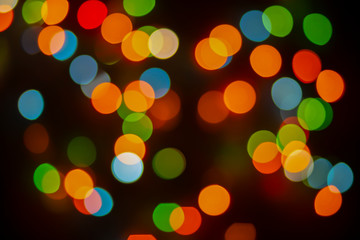 Abstract surface of bokeh, colorful, blurry background, blurred glare, large circular spots.Bright lights on dark background.
