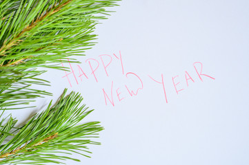 Happy new year - inscription on paper in a frame of pine branches. 2020 coming New year