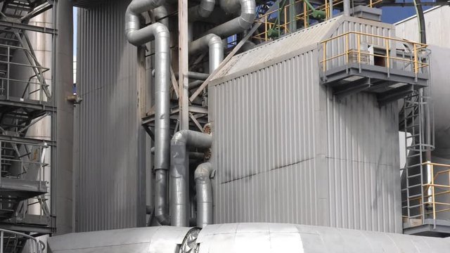 Equipment, pipelines and stairs installed outside of a modern industrial power station.