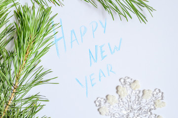 Happy new year - inscription on paper in a frame of pine branches. 2020 coming New year