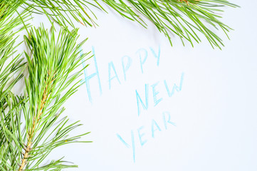 Happy new year - inscription on paper in a frame of pine branches. 2020 coming New year