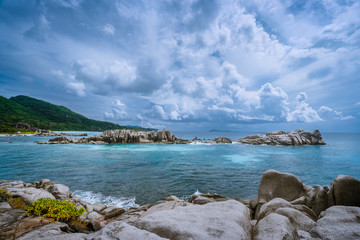 Tropical island landscape of beautiful beach with impressive clouds, Anse Marron, La Digue, Seychelles