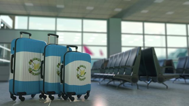 Travel suitcases with flag of Guatemala. Guatemalan tourism conceptual 3D animation