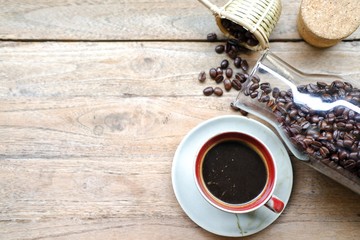 cup of coffee and beans on wooden table