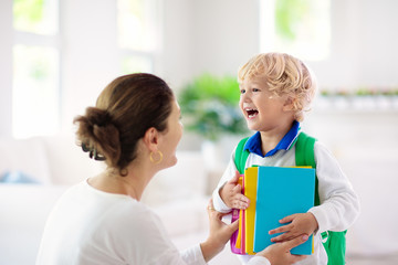 Child going back to school. Mother and kid.