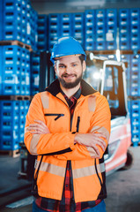 Worker in a forwarding company with his forklift