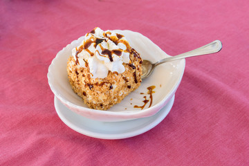 Italian ice cream dessert with topping and whipped cream