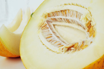 Ripe yellow melon on white background. Ripe yellow melon on a white table.