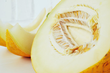 Ripe yellow melon on white background. Ripe yellow melon on a white table.