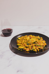 healthy lentils beans and vegetable curry recipe with wine glass on marble table