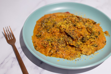 spicy vegetable curry recipe with nutritional yeast on marble table