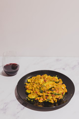 healthy lentils beans and vegetable curry recipe with wine glass on marble table