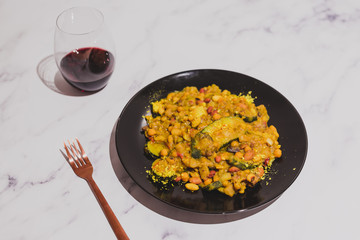 healthy lentils beans and vegetable curry recipe with wine glass on marble table