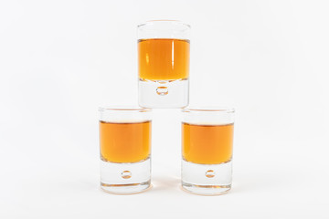 glass of whiskey and ice on white background