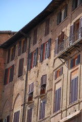 Fototapeta na wymiar Buildings in the Il Campo square in central Siena, Tuscany, Italy