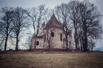 Old abandoned orhodox church inside the trees