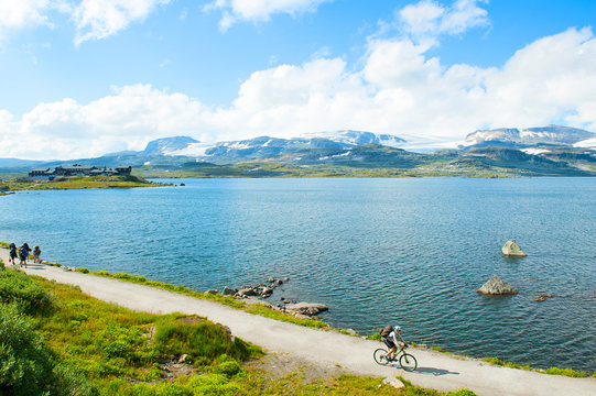 Tourists hiking and tourist biking in Finse, Norway on July 2019 
