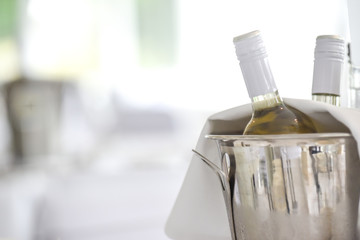 Wine bottles in an ice bucket on the restaurant table, white wine © tommoh29
