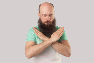 This is the end and no way more. Portrait of serious middle aged bald bearded man in green t-shirt...