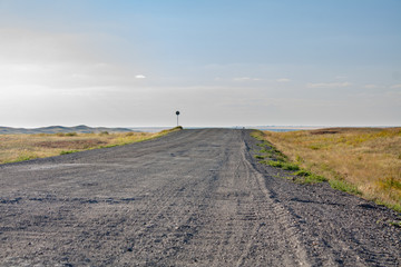 country road among the fields away from the city