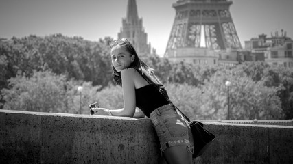 Fototapeta na wymiar Young woman relaxes at River Seine in Paris