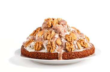 Homemade cake with milk cream, cocoa, almond, hazelnut isolated on white background. Side view.