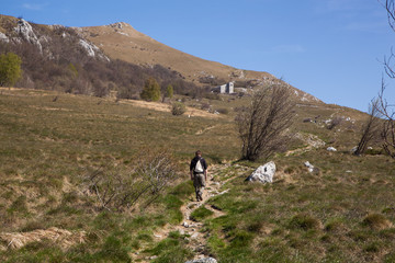 Fototapeta na wymiar A man walking towards the little church on a hill