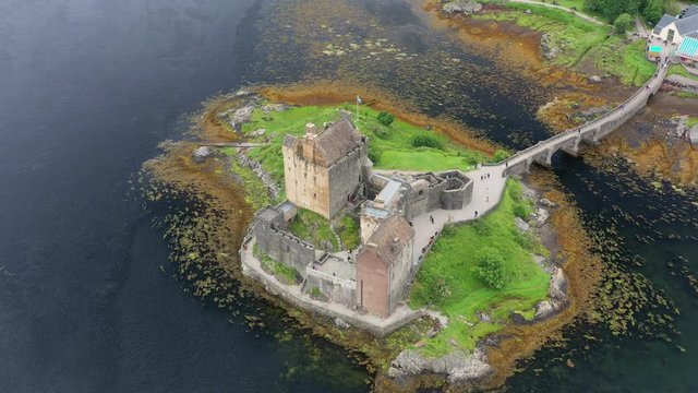 Aerial view of Eilean Donan Castle, medieval castle situated on tidal island on sea Loch Duich - landscape panorama of  Highlands of Scotland from above, Dornie, United Kingdom, Great Britain, Europe