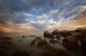 Coast seascape with rocks and clouds