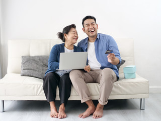 Asian man teaching his mother for shopping online, modern lifestyle concept.