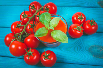 Fresh tomato juice as a source of vitamins. Wooden background.