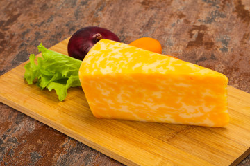 Marble cheese  triangle over wooden