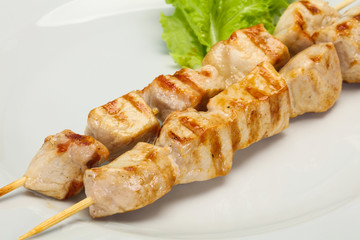 Grilled pork skewer served salad