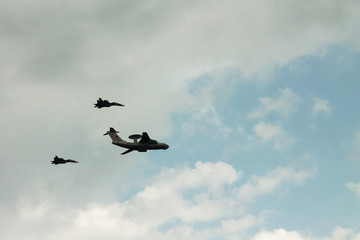 Naklejka na ściany i meble Saint-Petersburg. Russia. 28 July 2019. Parade in honor of the day of the Navy. Columns of planes high in the sky. Aircraft performance aerobatic team Swifts