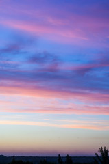 Landscape with dramatic light - beautiful golden sunset with saturated sky and clouds.