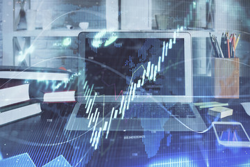 Financial chart drawing and table with computer on background. Multi exposure. Concept of international markets.