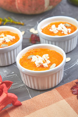 Cream of pumpkin soup or souffle on a gray background.  Thanksgiving Day. Diet vegetarian pupmkin soup puree. Rustic.