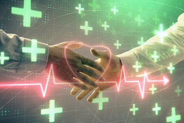 Multi exposure of heart hologram on abstract background with two men handshake. Concept of medical...
