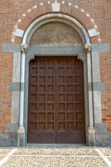 Fototapeta na wymiar medieval wooden arched church door Monza, Italy