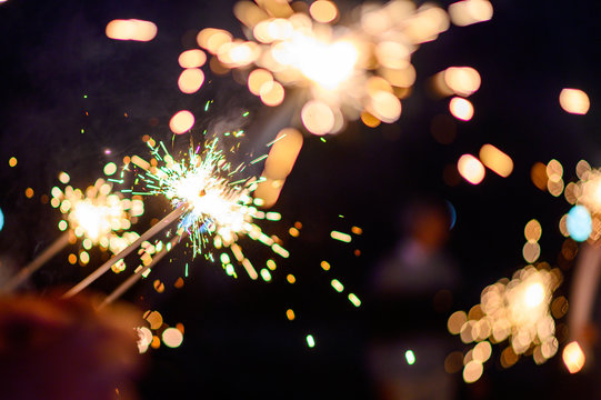 Man hand holding a burning sparkler. Bengal fire